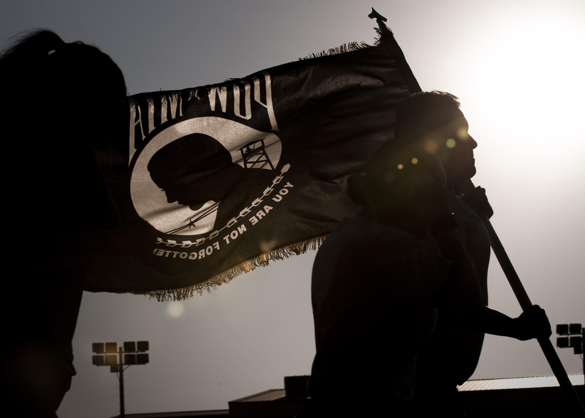 U.S. Air Force Airmen run with the Prisoner of War and Missing in Action flag during the POW/MIA Recognition Day at Kunsan Air Base, Republic of Korea, Sept. 14, 2017. Kunsan Airman and Soldiers participated in a 24-hour run in recognition of POW/MIA service members. This day was established by an Act of Congress, through the passage of Section 1082 of the 1998 Defense Authorization Act and is one of six days that the POW/MIA Flag can be flown.  (U.S. Air Force photo by Staff Sgt. Victoria H. Taylor)
