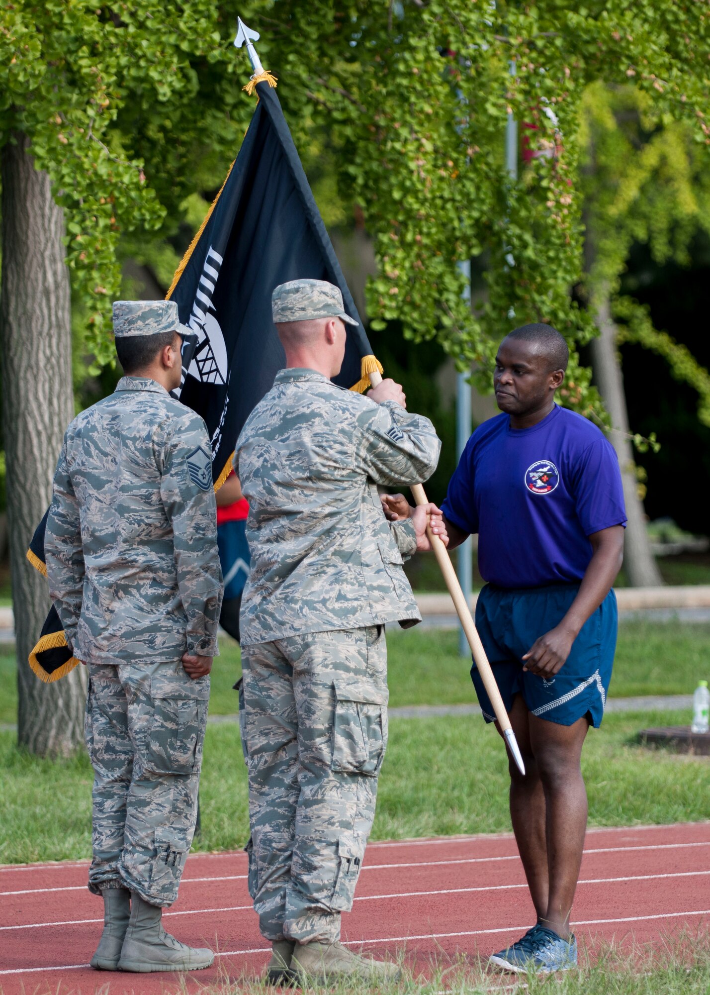 U.S. Air Force Airmen conclude running with the Prisoner of War and Missing in Action flag during the POW/MIA Recognition Day at Kunsan Air Base, Republic of Korea, Sept. 15, 2017. Kunsan Airman and Soldiers participated in a 24-hour run in recognition of POW/MIA service members. According to the Defense POW/MIA Accounting Agency, there are still 82,467 Americans still missing from past conflicts dating back to World War II. (U.S. Air Force photo by Staff Sgt. Victoria H. Taylor)