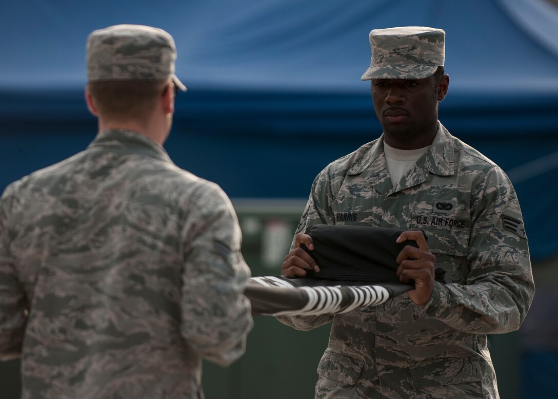 U.S. Air Force Senior Airman Ryan Harris, 8th Security Forces Squadron defender, folds the POW/MIA flag during the closing ceremony of the POW/MIA Recognition Day at Kunsan Air Base, Republic of Korea, Sept. 15, 2017.  The day was established by an Act of Congress, by the passage of Section 1082 of the 1998 Defense Authorization Act and is one of six days that the POW/MIA Flag can be flown. (U.S. Air Force photo by Staff Sgt. Victoria H. Taylor)