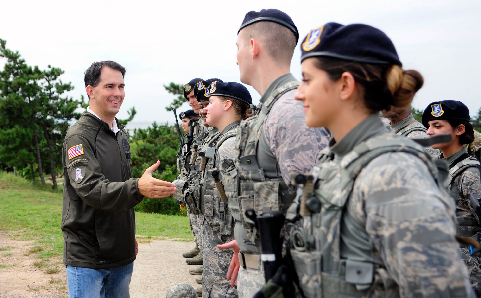 The Honorable Scott Walker, Governor of Wisconsin, greets Airmen from the 8th Security Forces Squadron, at Kunsan Air Base, Republic of Korea, Sept. 16, 2017. Walker visited Wisconsin Air National Guard 115th Fighter Wing Airmen deployed as part of a Theater Security Package and gained a greater understanding of the Wolf Pack’s mission. (U.S. Air Force photo by Senior Airman Colby L. Hardin)