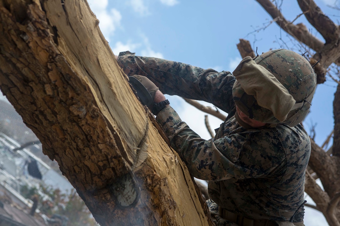 U.S. Marine Corps Sgt. Austin C. Morgan, an assaultman with Battalion Landing Team 2nd Battalion, 6th Marine Regiment, 26th Marine Expeditionary Unit (MEU), to clear debris at a local fire station that was affected by Hurricane Irma in St. John, U.S. Virgin Islands, Sept. 17, 2017.