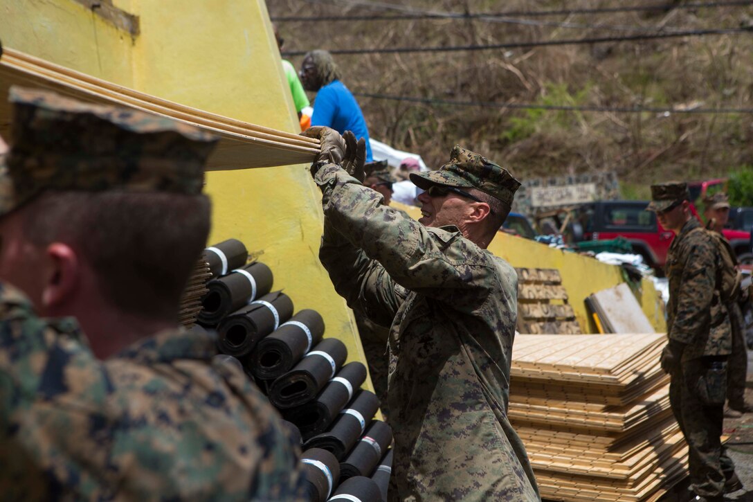 U.S. Marine Corps Sgt. Austin C. Morgan, an assaultman with Battalion Landing Team 2nd Battalion, 6th Marine Regiment, 26th Marine Expeditionary Unit (MEU), to clear debris at a local fire station that was affected by Hurricane Irma in St. John, U.S. Virgin Islands, Sept. 17, 2017.