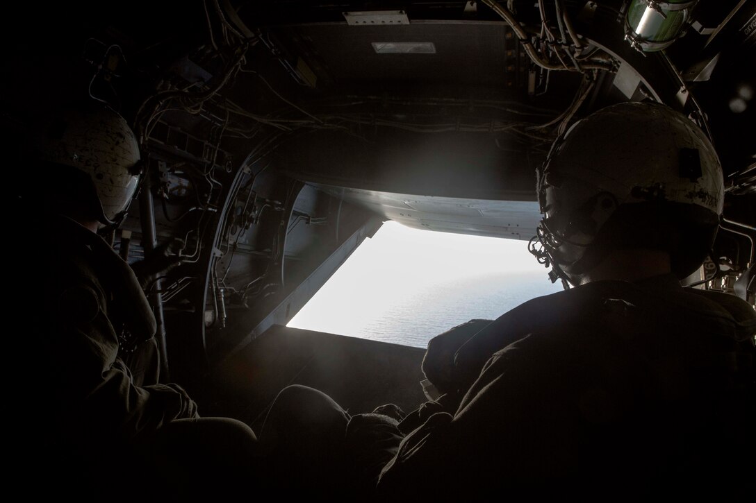 U.S. Marines with the 26th Marine Expeditionary Unit (MEU) maintain an aerial observation in a MV-22B Osprey aircraft while returning personnel and equipment to the amphibious assault ship USS Kearsarge (LHD 3) after conducting humanitarian aid and relief work in the aftermath of Hurricane Irma in St. John, U.S. Virgin Islands, Sept. 17, 2017. The 26th MEU is supporting authorities in the U.S. Virgin Islands with the combined goal of protecting the lives and safety of those in affected areas. (U.S. Marine Corps photo by Lance Cpl. Santino D. Martinez)