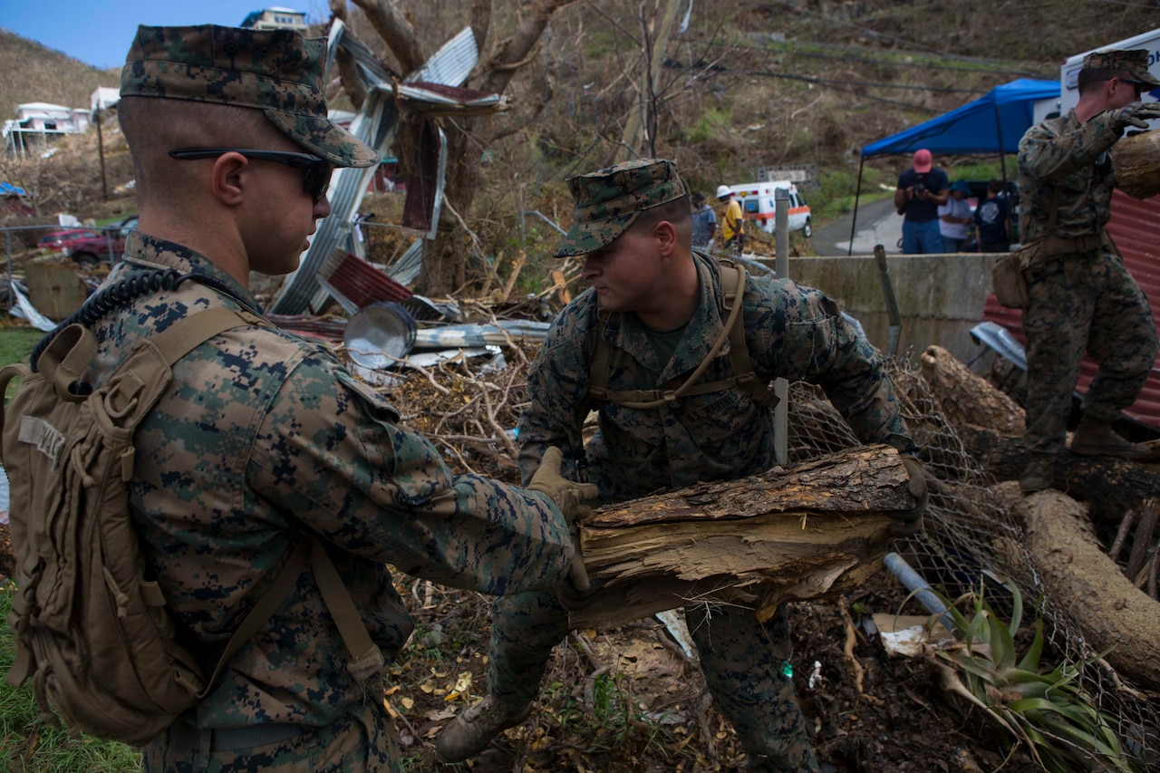 U.S. Marine Corps Sgt. Austin C. Morgan, an assaultman with Battalion Landing Team 2nd Battalion, 6th Marine Regiment, 26th Marine Expeditionary Unit (MEU), to clear debris at a local fire station that was affected by Hurricane Irma in St. John, U.S. Virgin Islands, Sept. 17, 2017.