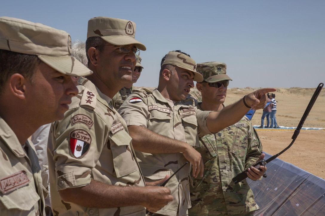 An Egyptian officer points out tank positions to U.S. Army Lt. Col. William Wade, commander of the 2nd Battalion, 7th Cavalry Regiment, 3rd Armored Brigade Combat Team, 1st Cavalry Division, at a combined arms live fire exercise (CALFEX) rehearsal during Exercise Bright Star 2017. More than 200 U.S. service members are participating alongside the Egyptian armed forces for the bilateral U.S. Central Command Exercise Bright Star 2017, Sept. 10 - 20, at Mohamed Naguib Military Base, Egypt. (U.S. department of Defense photo by Tom Gagnier)