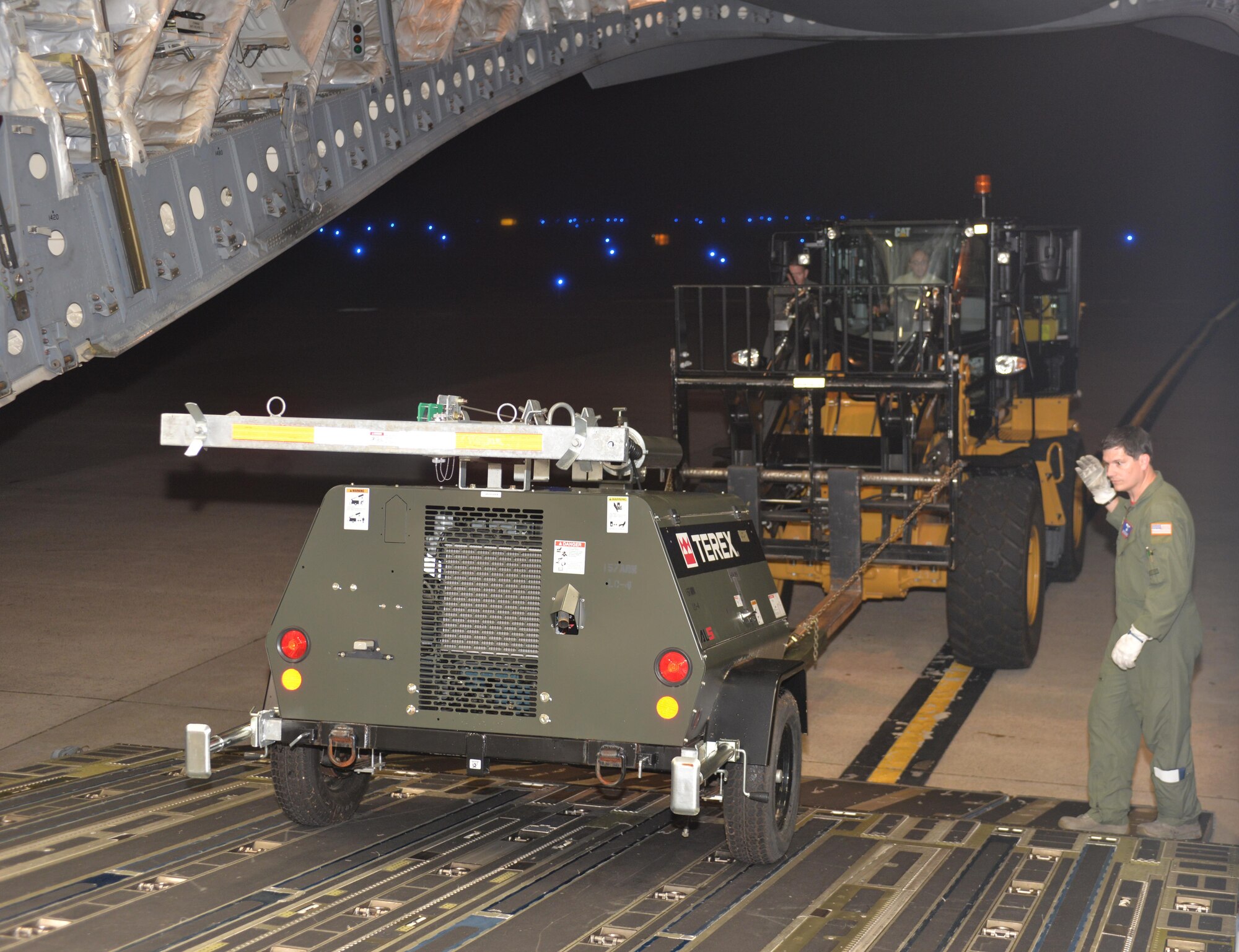 U.S. Air Force Master Sgt. Brandon Moseley, Loadmaster, 183rd Airlift Wing, Mississippi Air National Guard, guides a front end loader driven by Staff Sgt. Jose Pagan, air transportation craftsman, New Hampshire Air National Guard up a cargo ramp of a C-17A Globemaster. The Light Cart is part of the Disaster Relief Bed Down Kit (DRBS) deploying from Pease ANGB. to the Virgin Islands in support of the Irma relief effort.  The DRBS kit is one of two kits stored here at Pease Air National Guard Base.  (N.H. Air National Guard Photo by Master Sgt. Thomas Johnson)