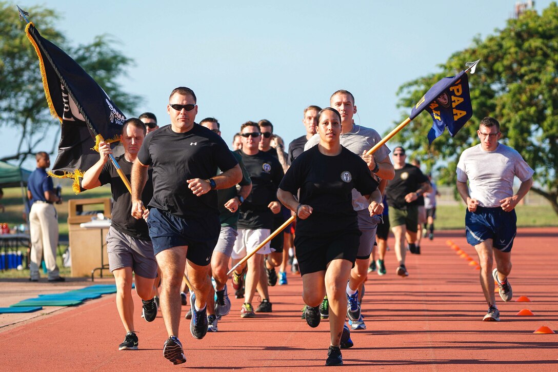 Service members run in honor of those who were prisoners of war and those who are still missing in action.