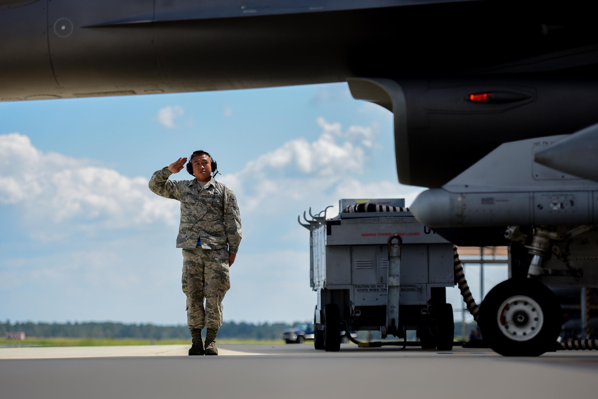 U.S. Airman 1st Class Luke Ikeda, a crew chief assigned to the 169th Aircraft Maintenance Squadron, salutes a F-16 Fighting Falcon fighter pilot assigned to the South Carolina Air National Guard’s 169th Fighter Wing at McEntire Joint National Guard Base, S.C., Sept. 16, 2017. Ikdea was recognized as an outstanding Airman by his supervisors and his peers and was the Airman Spotlight subject for the month of October. (U.S. Air National Guard photo by Senior Airman Megan Floyd)