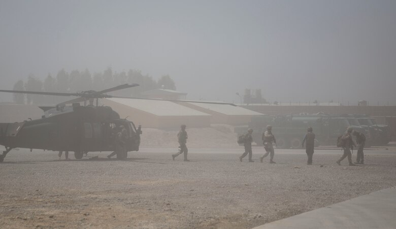 Wais Ahmad Barmak, the Minister of Interior for Afghanistan, and British Army Maj. Gen. Charles Herbert, the Resolute Support senior advisor to the MOI, disembark off a UH-60 Blackhawk for a key leader engagement with Afghan National Defense and Security Force key leaders at Bost Airfield, Afghanistan, Sept. 11, 2017. The key leaders came together to discuss a better way to streamline processes for supply, promotions, training opportunities, the distribution of vehicles and weapons, as well as what can be done to counter the corruption that is present in Helmand Province. (U.S. Marine Corps photo by Sgt. Justin T. Updegraff)