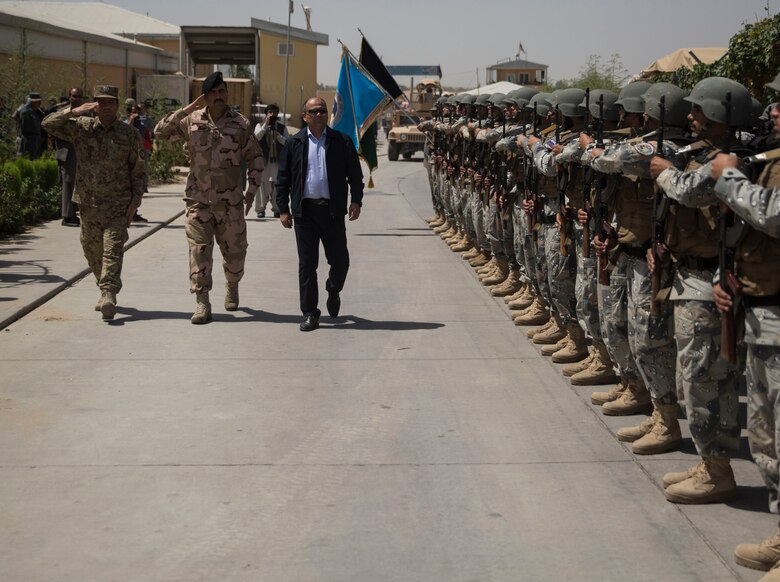 Wais Ahmad Barmak, right, the Minister of Interior for Afghanistan, Brig. Gen. Daud Ghulam Tarakhel, center, the commanding general of the 505th Zone National Police, are greeted by a formation of Afghan National Policemen at Bost Airfield, Afghanistan, Sept. 11, 2017. The key leaders came together to discuss a better way to streamline processes for supply, promotions, training opportunities, the distribution of vehicles and weapons, as well as what can be done to counter the corruption that is present in Helmand Province. (U.S. Marine Corps photo by Sgt. Justin T. Updegraff)