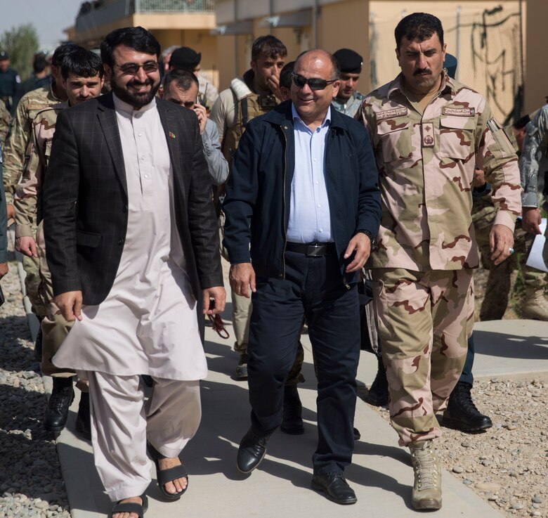 Wais Ahmad Barmak, center, the Minister of Interior for Afghanistan, Governor Hayatullah Hayat, left, the governor of Helmand Province, and Brig. Gen. Daud Ghulam Tarakhel, right, the commanding general of the 505th Zone National Police, walk and talk after the conclusion to a key leader engagement at Bost Airfield, Afghanistan, Sept. 11, 2017. The key leaders came together to discuss a better way to streamline processes for supply, promotions, training opportunities, the distribution of vehicles and weapons, as well as what can be done to counter the corruption that is present in Helmand Province. (U.S. Marine Corps photo by Sgt. Justin T. Updegraff)