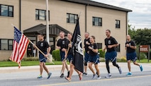 Col. Ethan Griffin, 436th Airlift Wing commander; Col. Corey Simmons, 436th AW vice commander; Chief Master Sgt. Sarah Sparks, 436th AW command chief; and four other members of Team Dover kick off the 24-hour run as part of the base’s two-day National Prisoner of War and Missing in Action Recognition Day events Sept. 14, 2017, on Dover Air Force Base, Del. A total of 343 runners participated in the 24-hour run that started at 4 p.m. and concluded Sept. 15 at 4 p.m. (U.S. Air Force photo by Roland Balik)