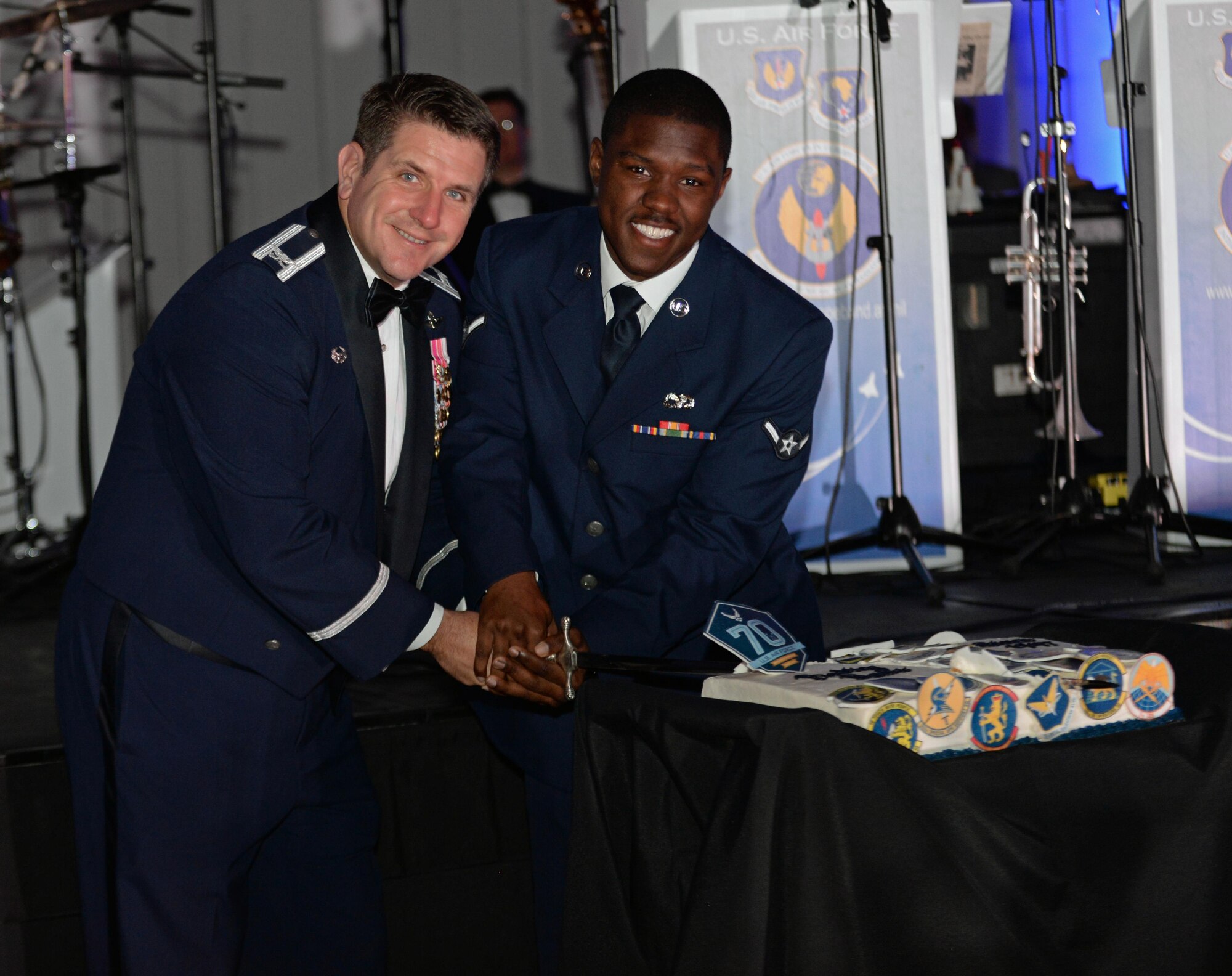 U.S. Air Force Col. Christopher Amrhein, 100th Air Refueling Wing commander, and U.S. Airman Leoncio Daniels, 100th Logistics Readiness Squadron ground transportation personnel, cut a birthday cake for the Air Force birthday celebration Sept. 16, 2017, in Duxford, England.  The U.S.  Air Force celebrates 70 years of service after becoming its own independent branch of the military on Sept. 18, 1947. (U.S. Air Force photo by Airman 1st Class Luke Milano)