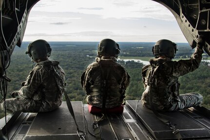 (From left) Sgt. John Harrington, a flight medic from Company C, 3-126th Aviation Regiment, sits next to Staff Sgt. Dave Gulino and Staff Sgt. Chris Moore - all part of the crew of a Connecticut Army National Guard CH-47 Chinook helicopter from Company B, 2-104th General Support Aviation Battalion, while completing a survey mission in northern Florida, Sept. 13, to evaluate river levels and damage along the Santa Fe and Ichetucknee rivers, while ensuring flooded areas were free of stranded civilians.
While conducting reconnaissance, the air crew indicated possible increased water levels, but the areas were deemed clear of any civilians in distress.
The crew of the CH-47 Chinook helicopter included eight of 14 Connecticut National Guard Soldiers currently operating out of the Florida National Guard’s Army Aviation Support Facility No. 1 in Jacksonville, Florida, in support of Hurricane Irma relief and recovery operations. The Connecticut National Guard has more than 40 Soldiers and Airmen who have been supporting hurricane relief efforts in Florida, Texas, Puerto Rico and the U.S. Virgin Islands over the past couple weeks.