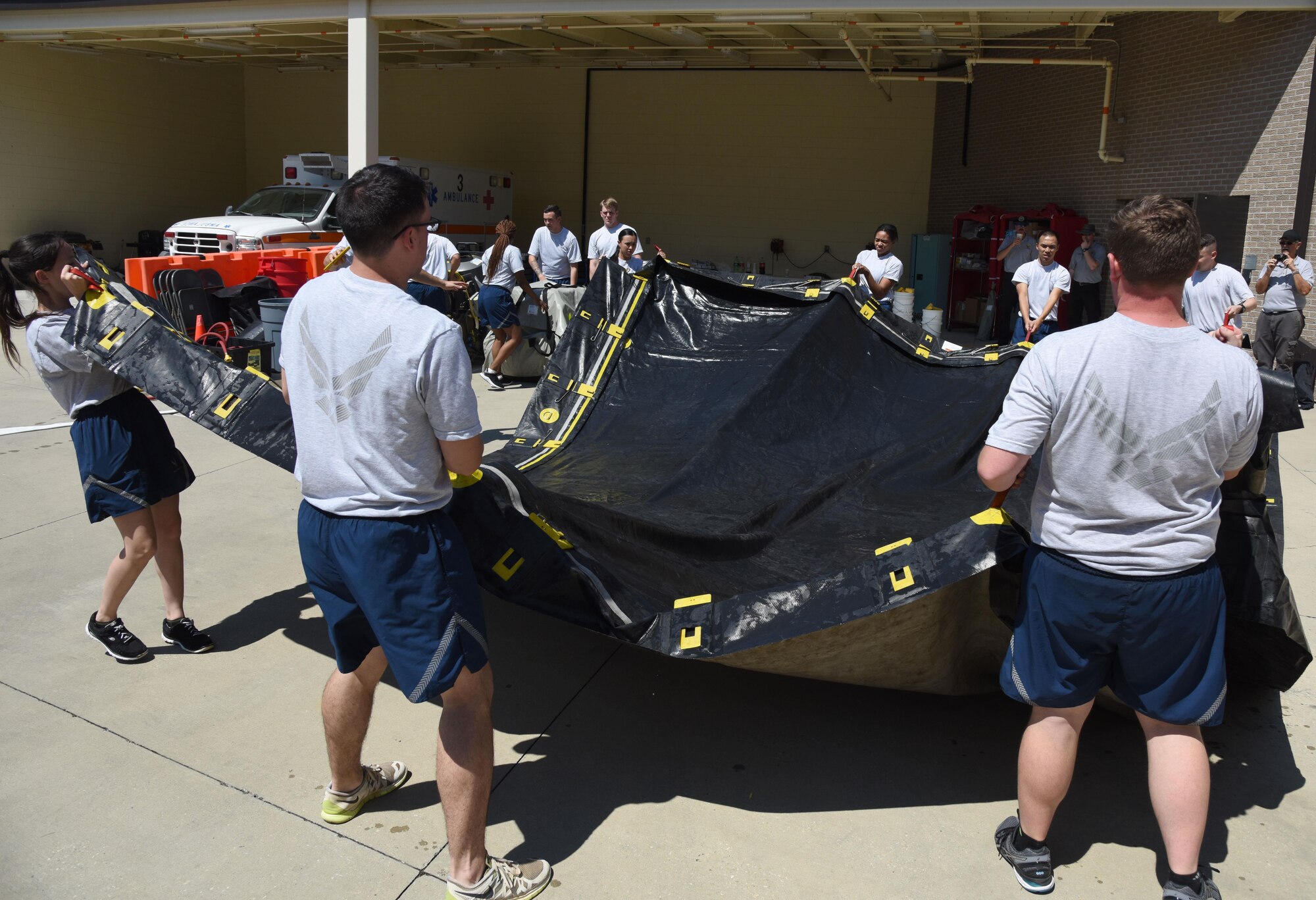 Members of the 81st Medical Group assemble a decontamination tent during the 81st MDG integrated in-place patient decontamination training course behind the Keesler Medical Center Sept. 14, 2017, on Keesler Air Force Base, Mississiippi. The two-day course trained 21 personnel, which came from four different disaster medical teams: IPPD , triage, manpower and security. Throughout the training, they learned to utilize Keesler’s fixed decontamination facility and how to set up and tear down the decontamination tent. (U.S. Air Force photo by Kemberly Groue)