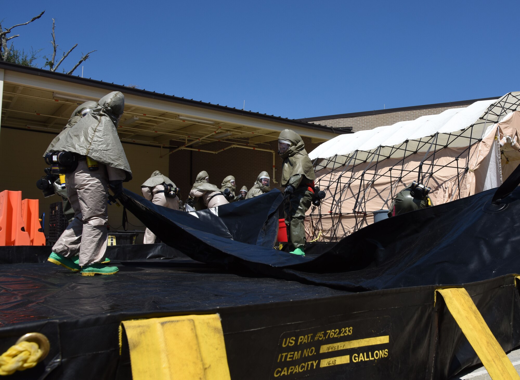 Members of the 81st Medical Group assemble a decontamination tent during the 81st MDG integrated in-place patient decontamination training course behind the Keesler Medical Center Sept. 14, 2017, on Keesler Air Force Base, Mississippi. The two-day course trained 21 personnel, which came from four different disaster medical teams: IPPD, triage, manpower and security. Throughout the training, they learned to utilize Keesler’s fixed decontamination facility and how to set up and tear down the decontamination tent. (U.S. Air Force photo by Kemberly Groue)