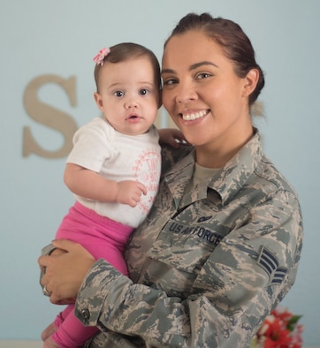 Senior Airman Shelby Horn poses for a portrait with her daughter Sadie