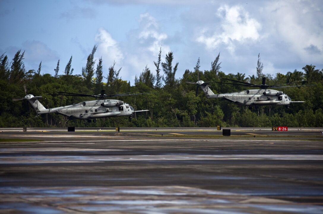 Helicopters lifting off from the runway.