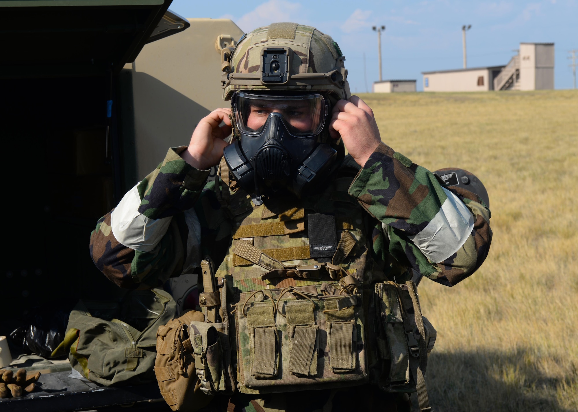 Senior Airman Parker Davis, an explosive ordnance disposal technician assigned to the 28th Civil Engineer Squadron, dons his protective gear during an EOD Team of the Year competition at Ellsworth Air Force Base, S.D., Sept. 12, 2017. During the competition, technicians were subjected to eight different scenarios that they needed to work through as part of a team of three. (U.S. Air Force photo by Airman Nicolas Z. Erwin)