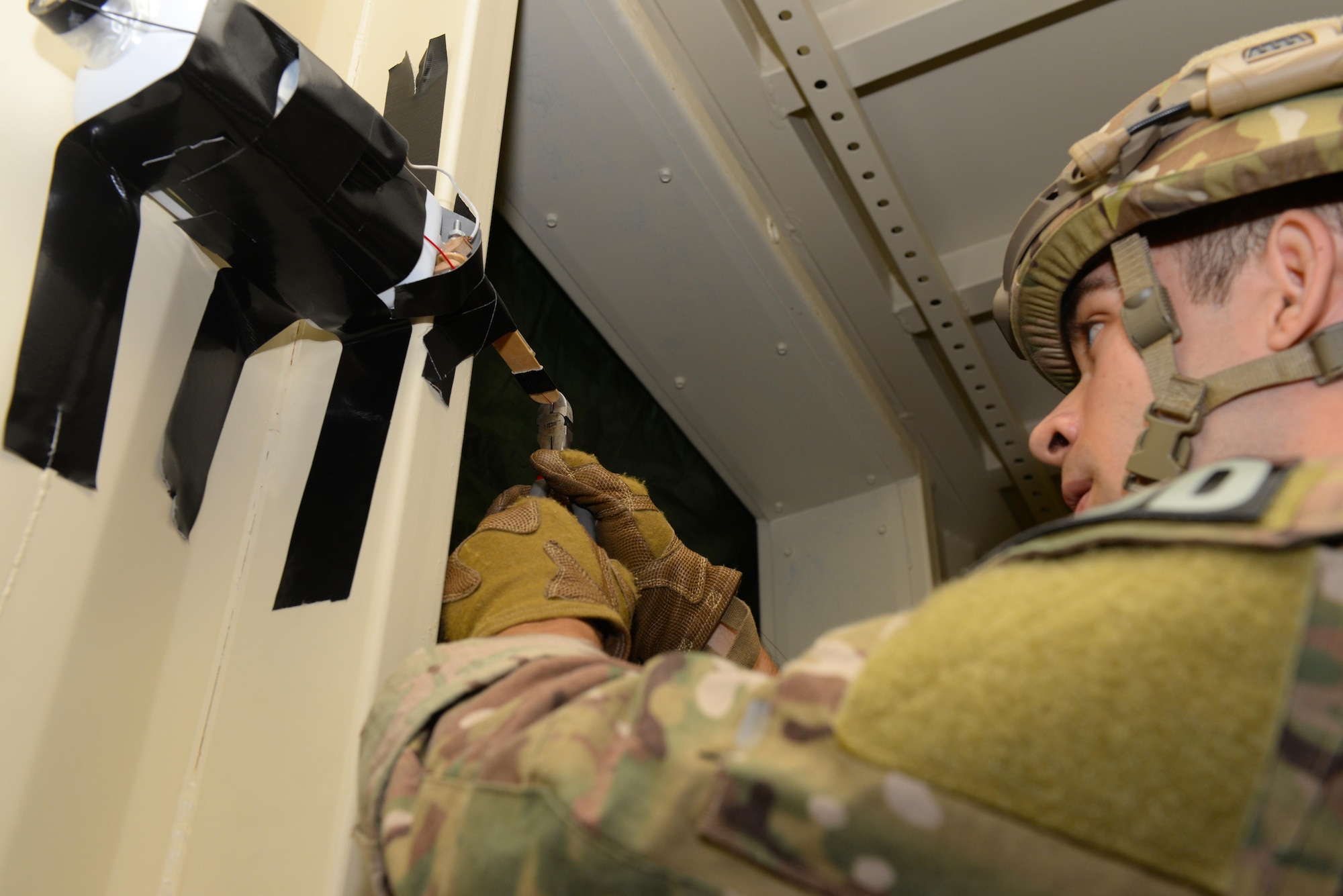 Airman 1st Class George Green, an explosive ordnance disposal technician assigned to the 28th Civil Engineer Squadron, disarms an improvised explosive device during an EOD Team of the Year competition at Ellsworth Air Force Base, S.D., Sept. 14, 2017. The competition lasted four days to allow all teams to attempt each scenario. (U.S. Air Force photo by Airman Nicolas Z. Erwin)