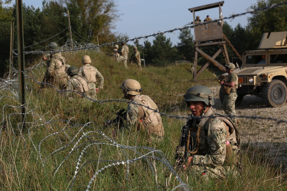 Georgian soldiers from the 31st Light Infantry Battalion provide security during a react-to-contact scenario as part of a mission rehearsal exercise at the Joint Multinational Readiness Center in Hohenfels, Germany, Aug. 22, 2017. The Marine Corps-led exercise involved nearly 900 troops from Georgia, Hungary and the U.S. Army photo by Spc. Keion Jackson