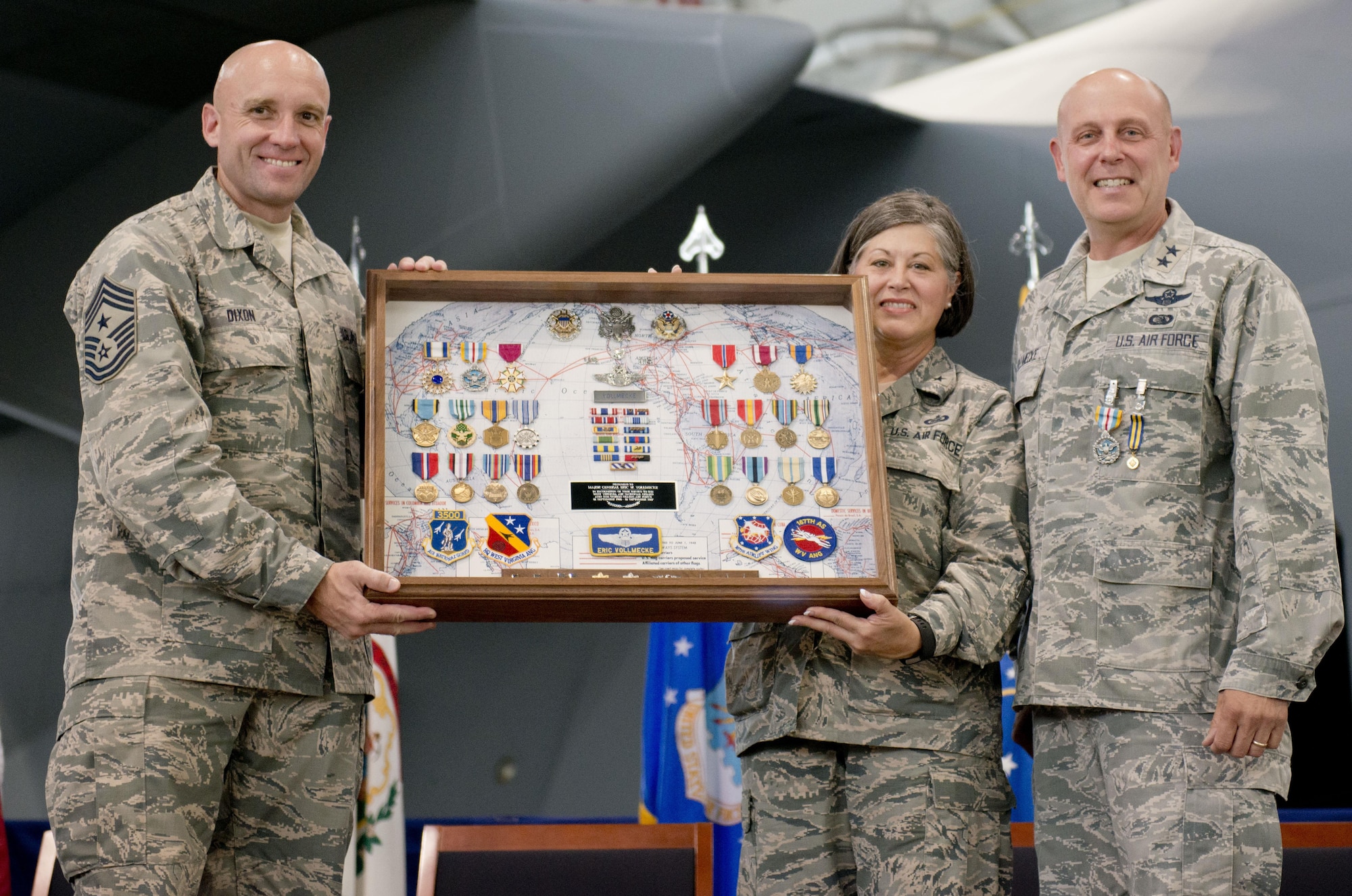 West Virginia Air National Guard Command Chief, Chief Master Sgt. James Dixon and Brig. Gen. Paige Hunter, Assistant Adjutant General, West Virginia Air National Guard, present Maj. Gen. Eric Vollmecke with a shadow box during his retirement ceremony at the 167th Airlift Wing, Martinsburg, W.Va., Sept. 16.