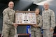 West Virginia Air National Guard Command Chief, Chief Master Sgt. James Dixon and Brig. Gen. Paige Hunter, Assistant Adjutant General, West Virginia Air National Guard, present Maj. Gen. Eric Vollmecke with a shadow box during his retirement ceremony at the 167th Airlift Wing, Martinsburg, W.Va., Sept. 16.