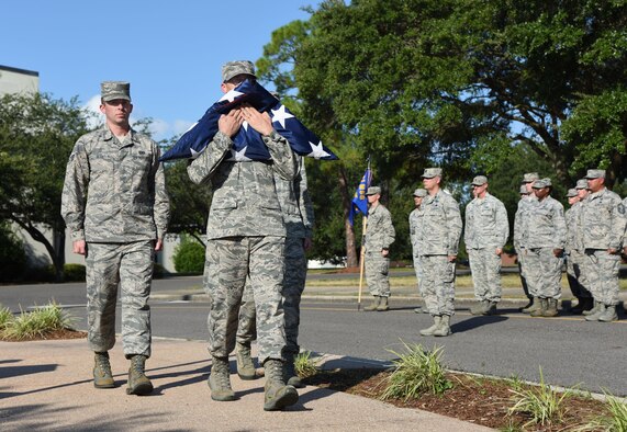 Keesler personnel participate in a flag folding ceremony during the POW/MIA Retreat Ceremony Sept. 15, 2017, on Keesler Air Force Base, Mississippi. The event, hosted by the Air Force Sergeants Association Chapter 652, was held to raise awareness and pay tribute to all prisoners of war and military members still missing in action. (U.S. Air Force photo by Kemberly Groue)