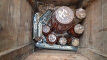 Jars containing potentially explosive chemicals are positioned in a wooden box with C-4 demolition explosives at the Big Seven mining complex Sept. 14, 2017, in Neihart, Mont.