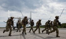 Airmen from the 23rd Special Tactics Squadron, Hurlburt Field, Fla., return to their vehicle after loading a passenger