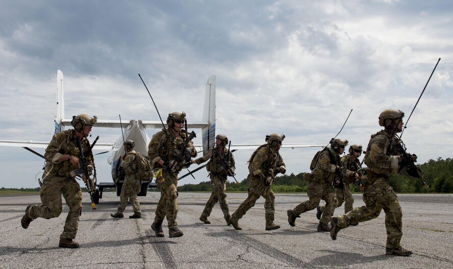 Airmen from the 23rd Special Tactics Squadron, Hurlburt Field, Fla., return to their vehicle after loading a passenger