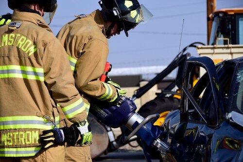 Members of the Malmstrom Air Force Base Fire Department use the Jaws of Life to remove a victim from a simulated car crash on Malmstrom Air Force Base Aug. 12, 2017.