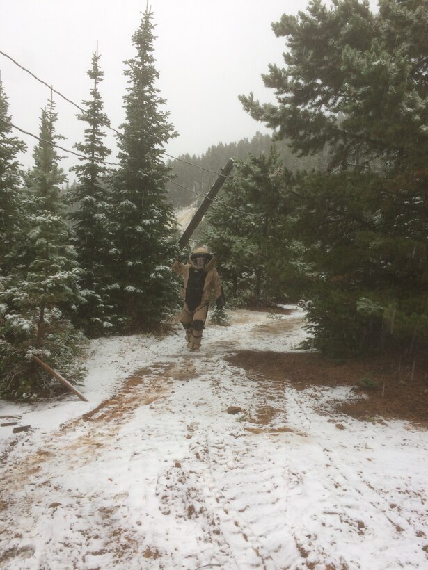 Tech. Sgt. Daniel Esselstrom, 341st Civil Engineer Squadron NCO in charge of explosive ordnance disposal and team lead for the demolition operation, walks away from the detonation site at the Big Seven mining complex Sept. 14, 2017, in Neihart, Mont.