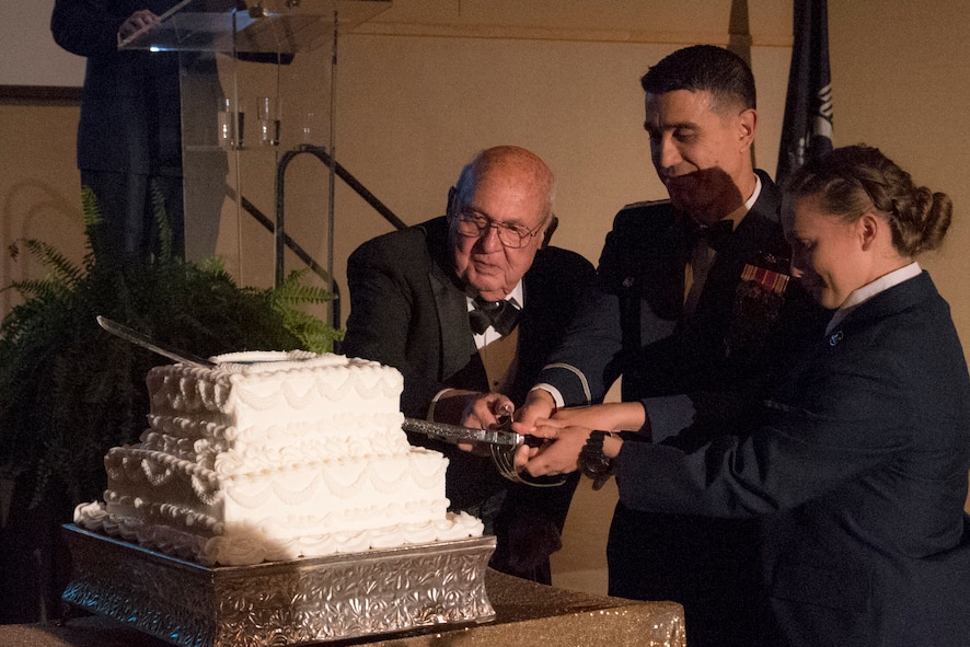 Air Force tradition is to have the oldest and the youngest service member cut the cake during the Air Force Ball held at the McNease Convention Center in San Angelo, Texas, Sept. 15, 2017.  The honor went to U.S. Air Force retired Col. Charlie Powell who was the oldest member and the youngest was Airman Hannah Guthrie, 315th student.  (U.S. Air Force photo by Airman Zachary Chapman/Released)