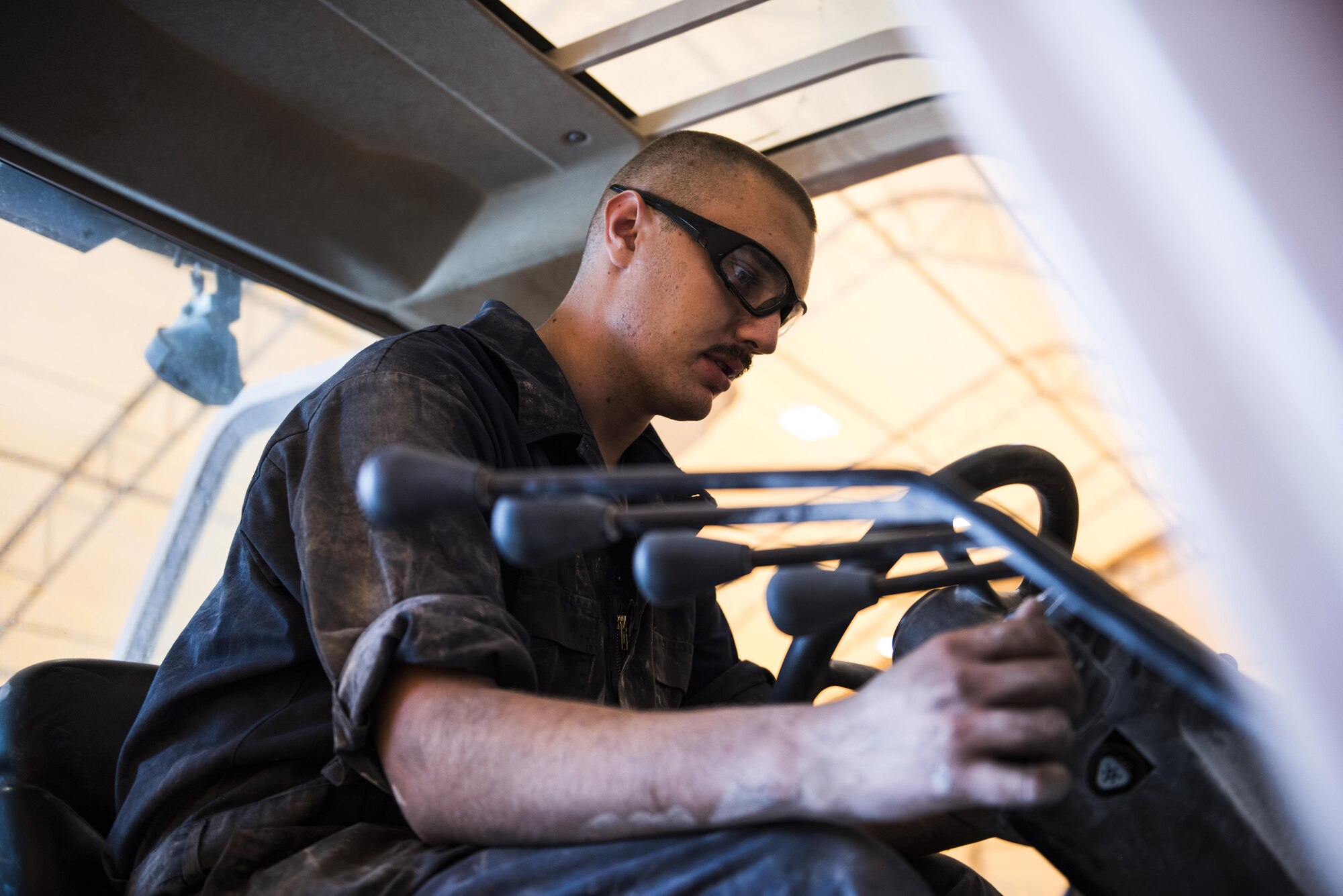 A vehicle maintainer assigned to the 332nd Expeditionary Logistics Readiness Squadron, diagnoses an issue with the controls on a forklift, Sept. 14, 2017, in Southwest Asia. Vehicle maintenance Airmen contribute directly to the mission by ensuring that vehicles used to fuel aircraft, deliver food and equipment, maintain installation security, construct new facilities and transport weapons are all kept in good operating condition. (U.S. Air Force photo by Senior Airman Joshua Kleinholz)