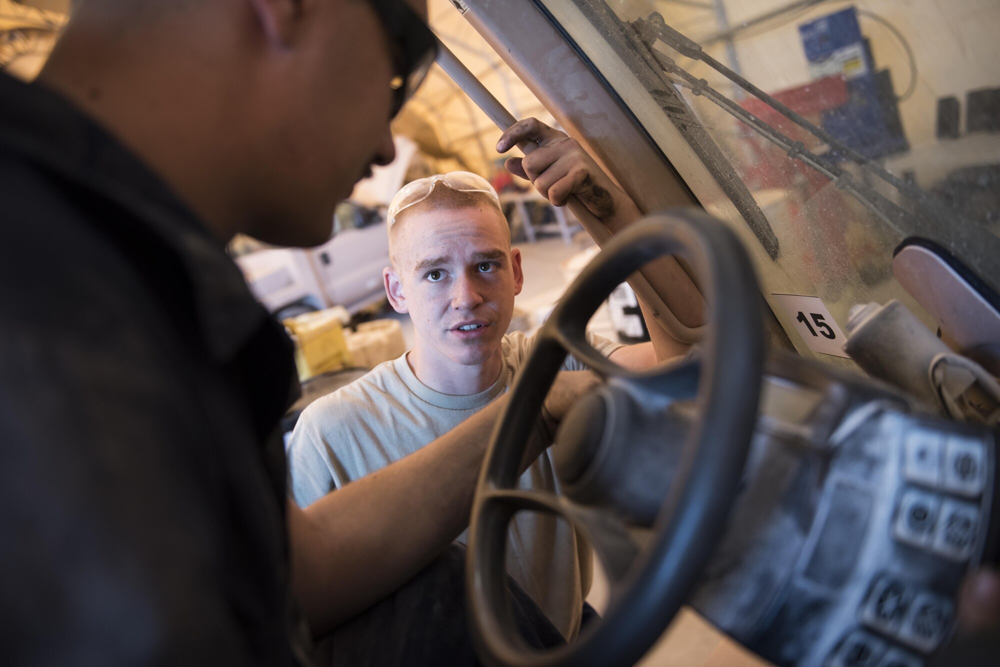 Vehicle maintainers assigned to the 332nd Expeditionary Logistics Readiness Squadron, diagnose an issue with the controls on a forklift, Sept. 14, 2017, in Southwest Asia. Tasked with maintaining a variety of unique and specialty vehicles, Airman mechanics must train continuously and pass along knowledge to ensure organizational competency. (U.S. Air Force photo by Senior Airman Joshua Kleinholz)