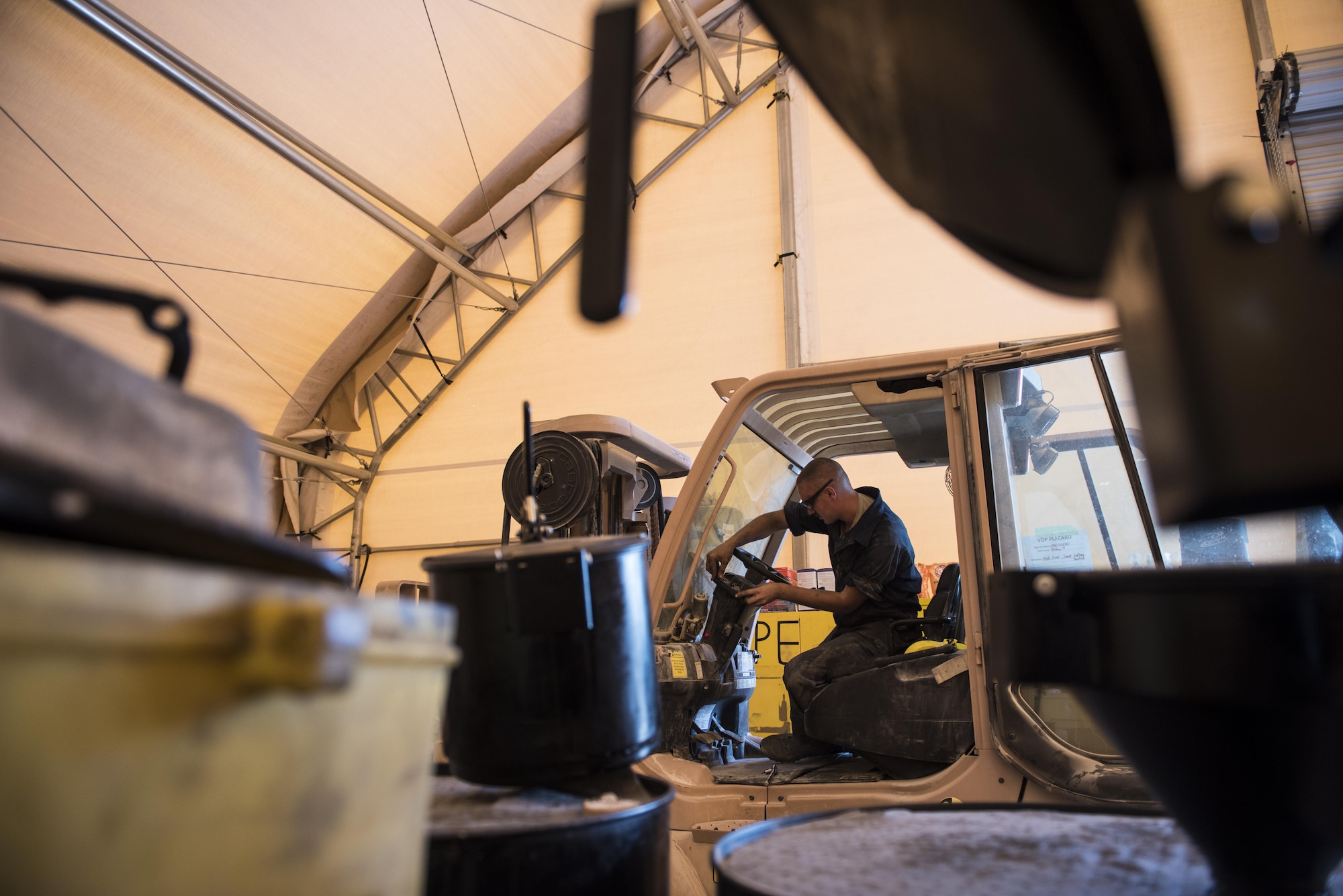 A vehicle maintainer assigned to the 332nd Expeditionary Logistics Readiness Squadron, diagnoses an issue with the controls on a forklift Sept. 14, 2017, in Southwest Asia. Maintainers are trained to inspect, diagnose and repair a multitude of different common and specialty Air Force vehicles.  (U.S. Air Force photo by Senior Airman Joshua Kleinholz)