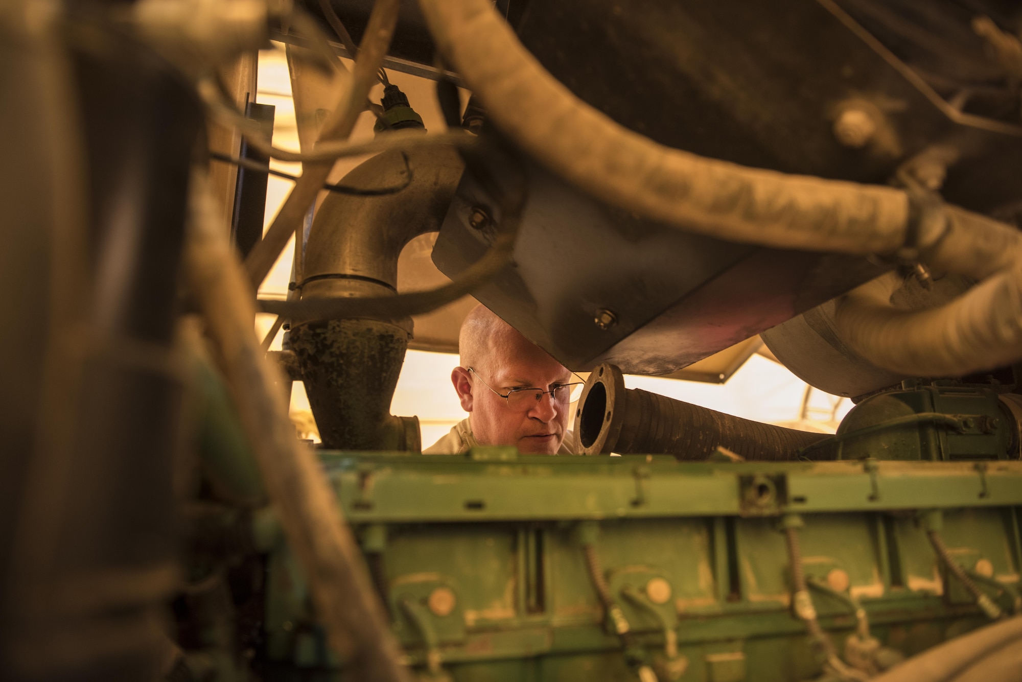 Staff Sgt. Nicholas Gucwa, 332nd Expeditionary Logistics Readiness Squadron vehicle maintainer, replaces parts on the diesel engine of an industrial road grader, Sept. 14, 2017, in Southwest Asia. Vehicle maintenance Airmen contribute directly to the mission by ensuring that vehicles used to fuel aircraft, deliver food and equipment, maintain installation security, construct new facilities and transport weapons are all kept in good operating condition. (U.S. Air Force photo by Senior Airman Joshua Kleinholz)