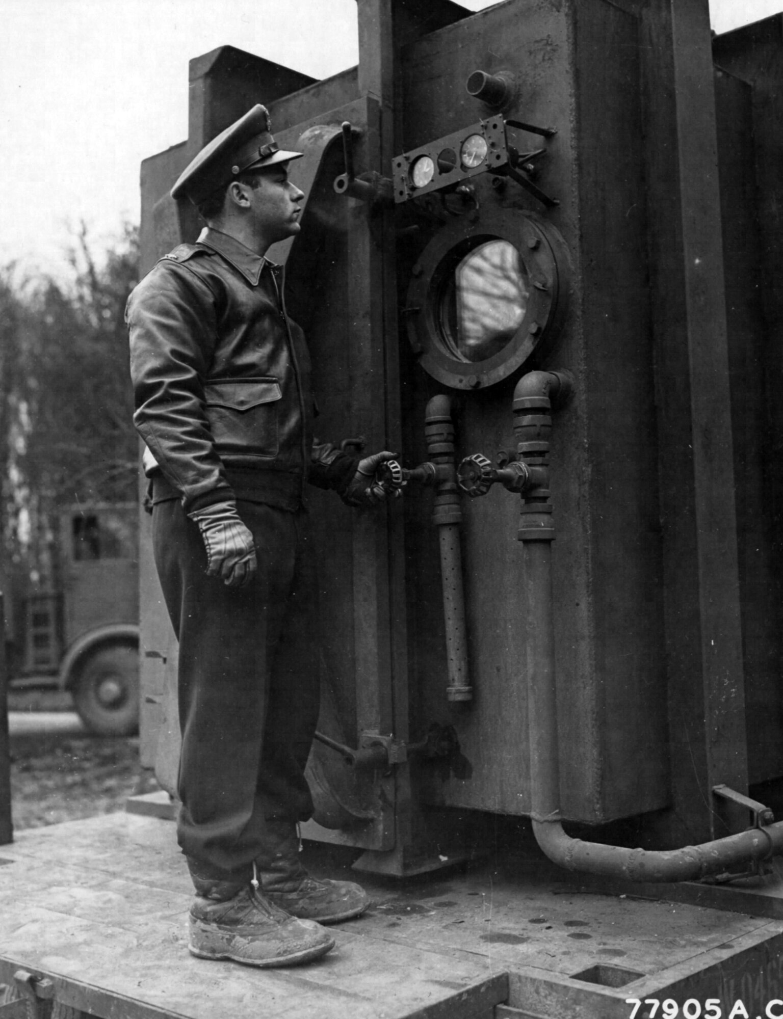 1st Lt. Richard J. Trockman, Evansville, Indiana, at the escape hatch of a low pressure chamber. This chamber is in use by the U.S. Air Force, Headquarters 8th Air Force Provisional Medical Field Service School, High Wycombe, England and is for the purpose of testing the airmen’s general physical condition. 24 Feb 1943 (Photo courtesy of the National Archives)