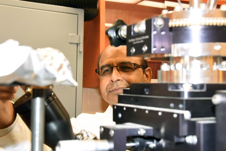 Dr. Ajit Roy, Air Force Research Laboratory's Computational Nanomaterials of the Materials and Manufacturing Directorate principal engineer and group lead uses a Physical Vapor Deposition system set up for thin film materials deposition on a substrate. (Air Force Photo/David Dixon)