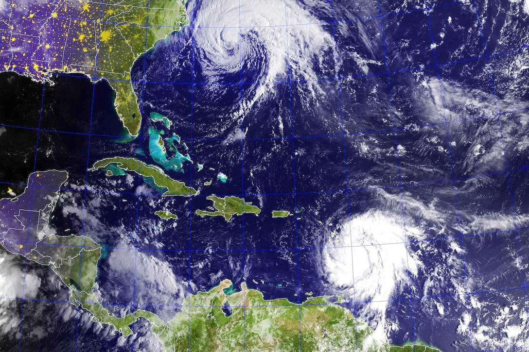Satellite image shows two hurricanes, land and water.