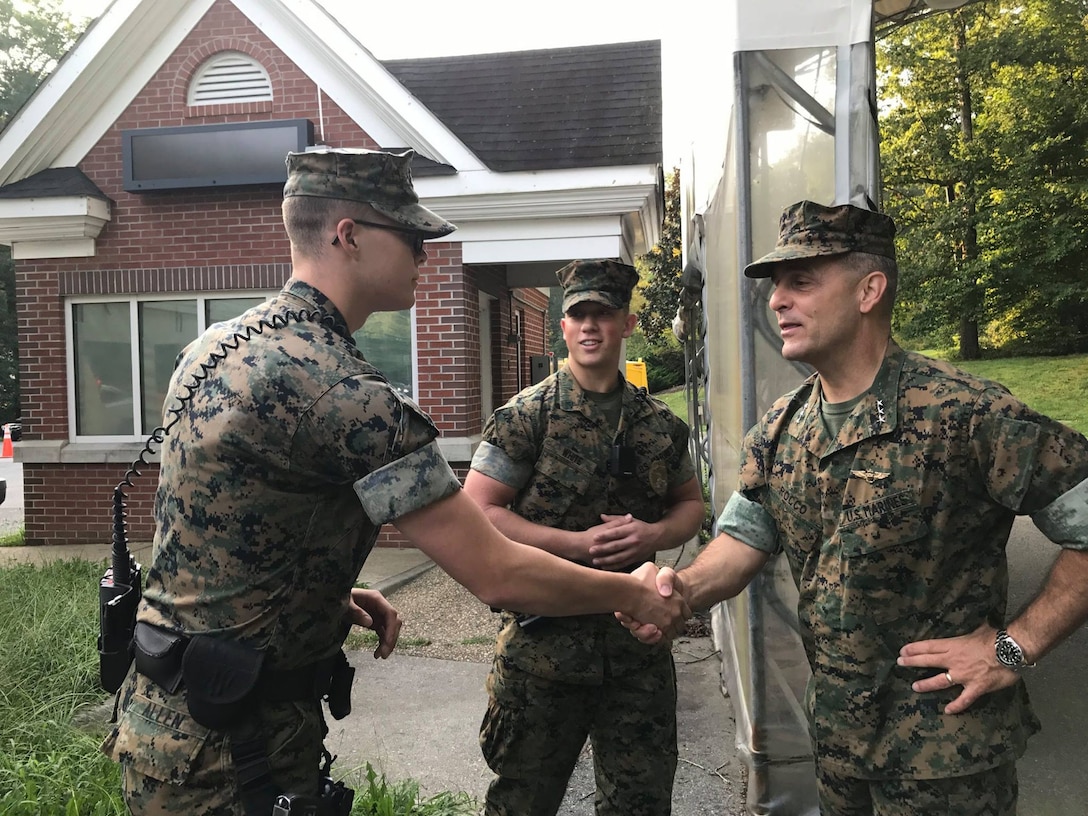 Lt. Gen. Michael Rocco, deputy commandant for Manpower and Reserve Affairs joined Marines from Security Battalion, LCpl Bryce W. Allen (left) and  LCpl Brandon L. White (right) Aug. 31 at the main gate to wish a happy and safe Labor Day weekend to service members and civilians entering the base.  They took the opportunity to hand out resource information related to September's National Suicide Prevention Awareness Month.