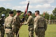 (Second from left) Command Sgt. Maj. Jeffrey Darlington, command sergeant major of the 80th Training Command, hands the unit's colors to outgoing commander Maj. Gen. A.C. Roper at the 80th's change of command ceremony at Fort Lee, Virginia, Sept. 17, 2017.