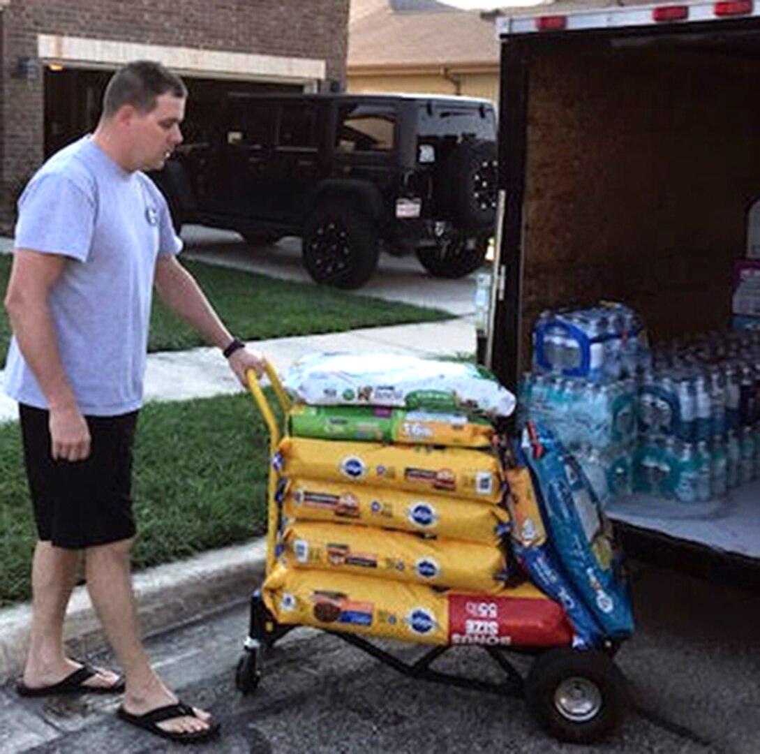 Capt. Gary E. Miller, of U.S. Army 5th Medical Recruiting Battalion, loads donated dog food into a trailer outside his home in Converse, Texas.  He collected and delivered approximately 1,500 pounds of food, water and supplies to the American Red Cross in San Antonio Sept. 2 to aid in Hurricane Harvey relief efforts.