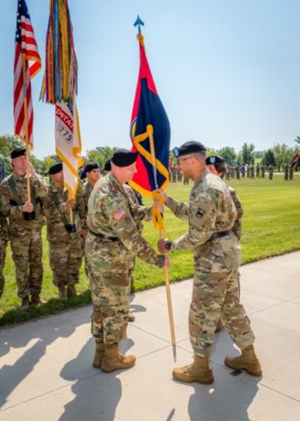 Left, newly promoted Brig. Gen. Michael Harvey receives the colors from Maj. Gen. A.C. Roper, signifying his taking command of the 102nd Training Division during a ceremony held Sept. 9 on Fort Leonard Wood's MSCoE Plaza.