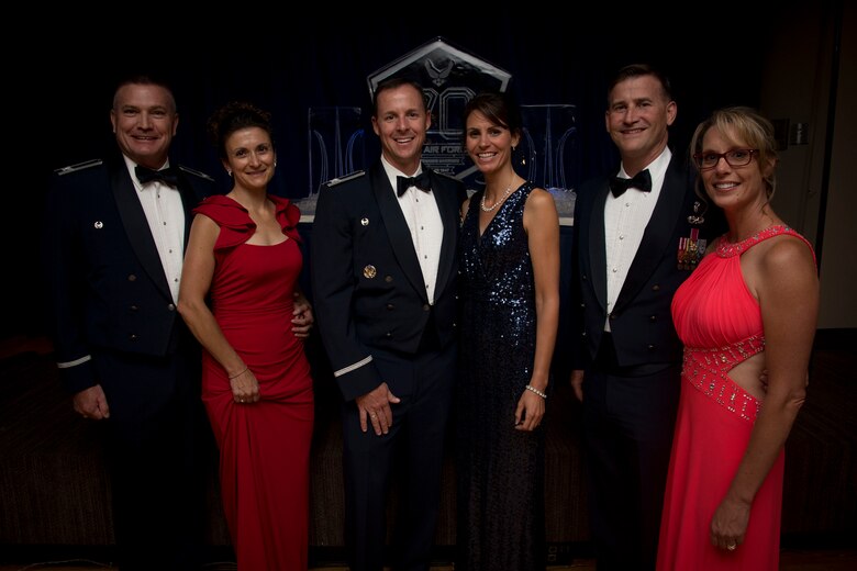 Col. Todd Moore (middle), 21st Space Wing commander, with wife, Kelly, Col. Eric Dorminey (left), 21st Space Wing vice commander, with wife, Jennifer, and Chief Master Sgt. Mark Bronson (right), 21st SW command chief, with wife, Sharon, attend the Air Force Ball on Peterson Air Force Base, Colorado, Sept. 15, 2017. The Air Force Ball was a formal night of celebration filled with dinner and dancing. (U.S. Air Force photo by Senior Airman Dennis Hoffman)