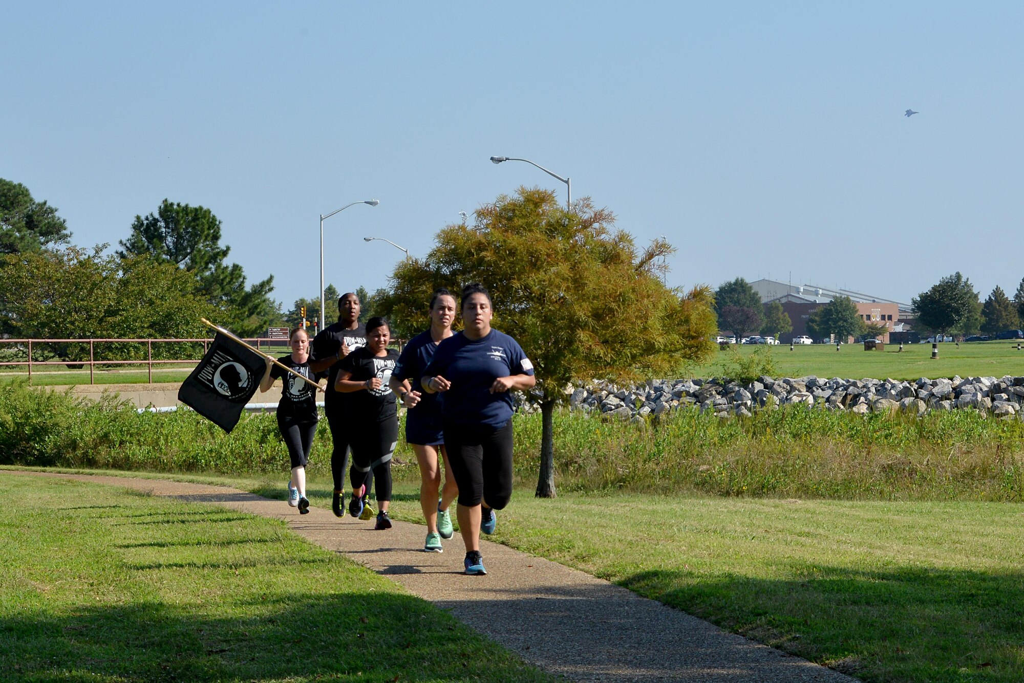 The last group of volunteers run to Memorial Park to hand off the POW/MIA flag at the end of the 24-hour vigil run at Joint Base Langley-Eustis, Va., Sept. 15, 2017.