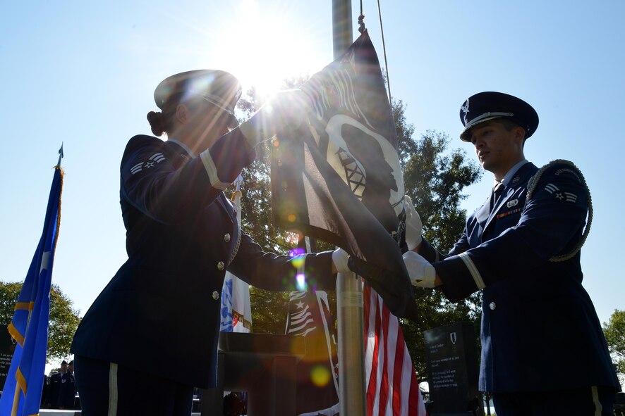 Langley Air Force Base Honor Guard members raise the POW/MIA flag during the POW/MIA Remembrance Day ceremony at Joint Base Langley-Eustis, Va., Sept. 15, 2017.