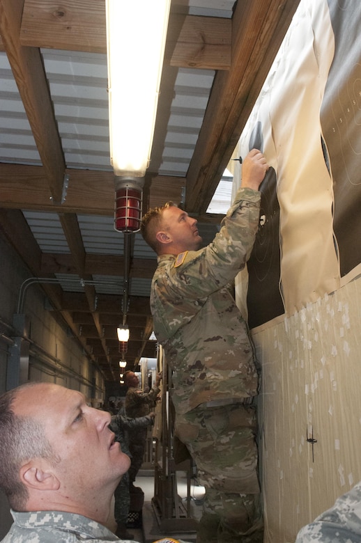 Sgt. Jared Henderson, of Kuna, Idaho, a combat engineer with the 391st Engineer Company, Boise, Idaho, marks targets for other teams firing the M-16A2 rifle at Fort McCoy, Wisconsin, during the Army Reserve Small Arms Championship.