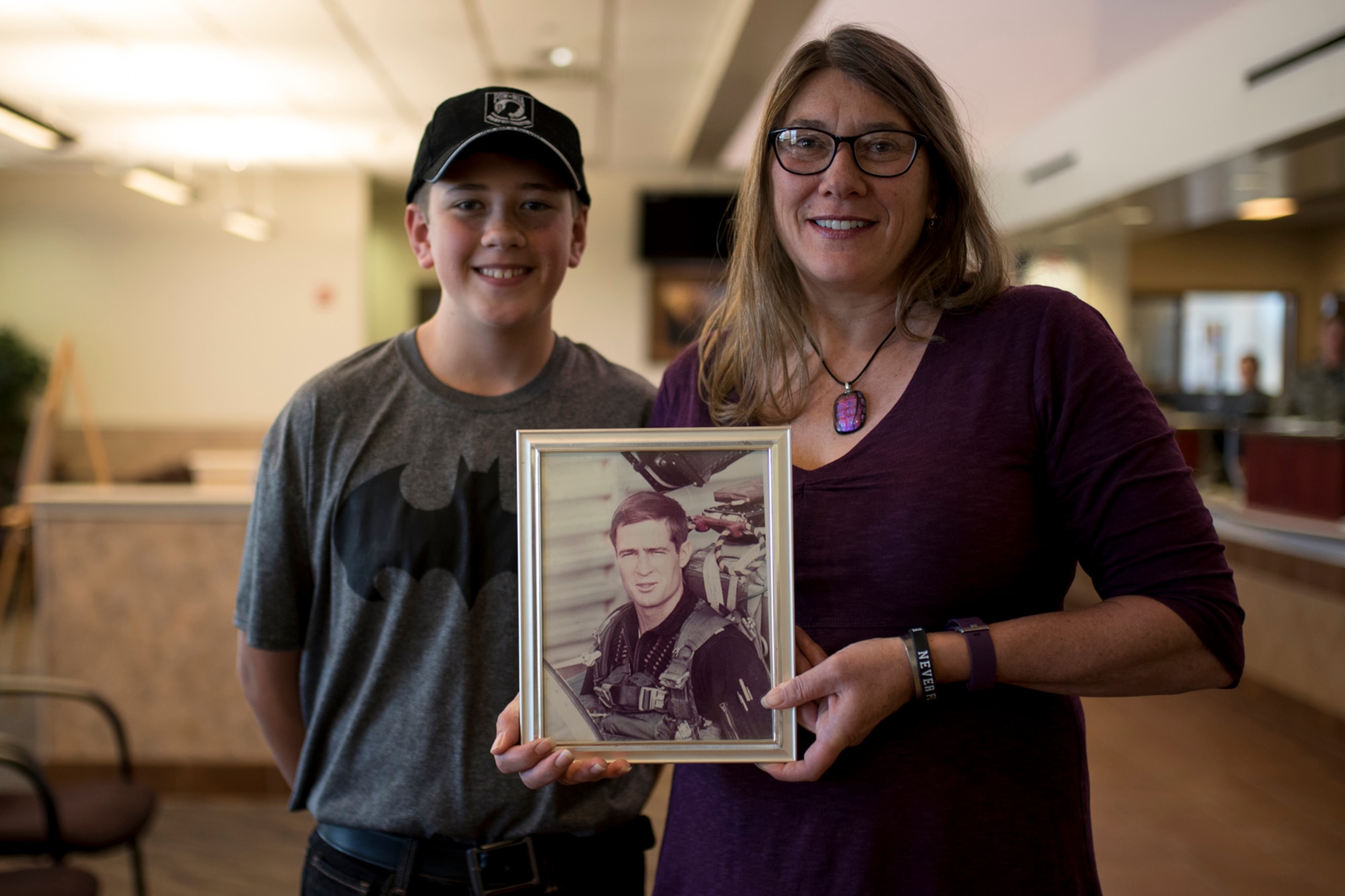 Karin Steadman with her son, Steadman James Brunson, holds a photo of her father at the Visitor Center on Peterson Air Force base, Colorado, Sept. 15, 2017. Karin’s Father, Capt. James Steadman, was declared killed in action in 1975. Steadman and her son, who was named for his grandfather, were at Peterson AFB to take advantage of the Gold Star Base Access ID Program that was instituted earlier this year. (U.S. Air Force photo by Senior Airman Dennis Hoffman)